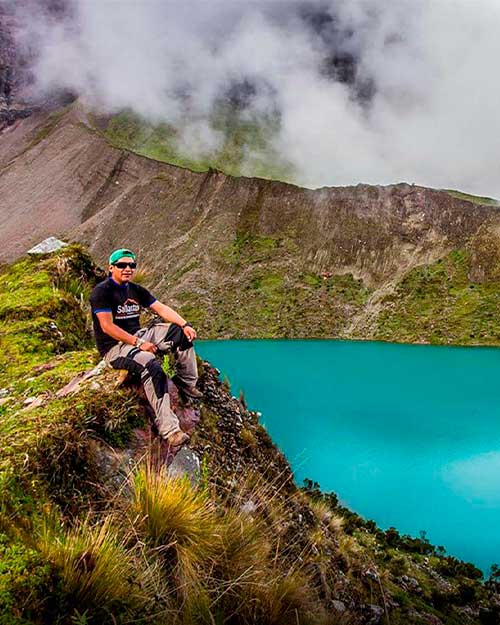 Man sitting on a rock in the  Humantay Lake