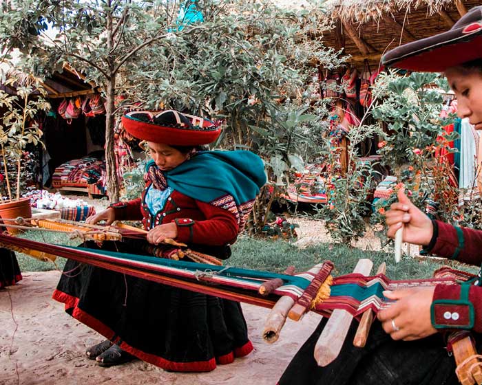 Andean woman making her traditional textiles