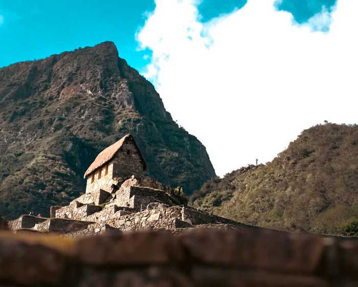 Woman hiking the incredible ancient Inca Trail to Machu Picchu near the cliff