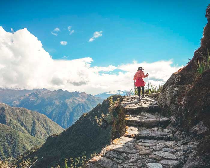 Woman hiking the incredible ancient Inca Trail to Machu Picchu near the cliff